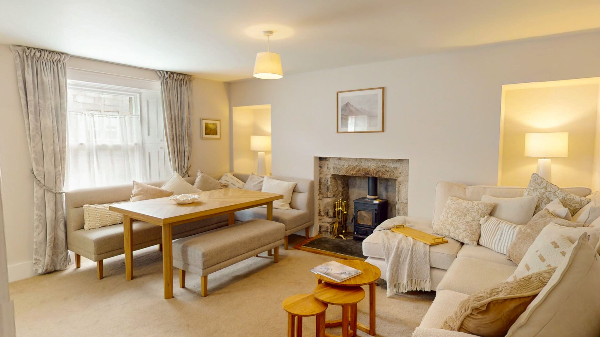 Open-plan living and dining room at The Twinflower, with a wood-burning fireplace