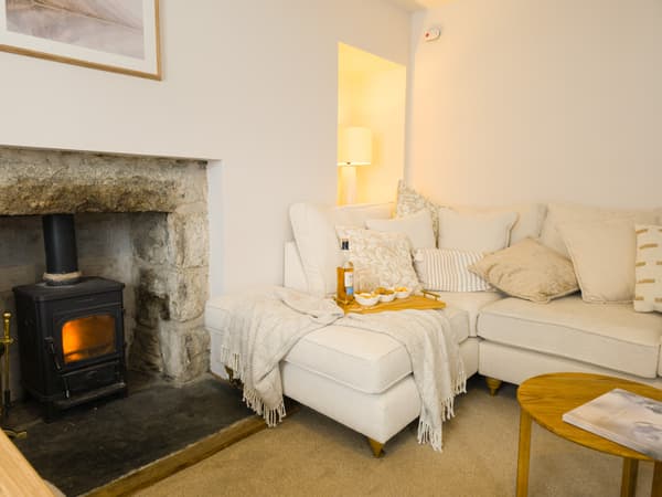 Cream corner sofa beside the fireplace