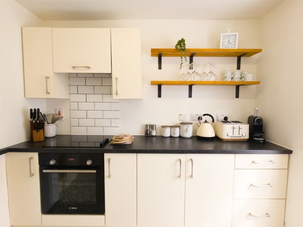 Kitchen with cream units and open shelving