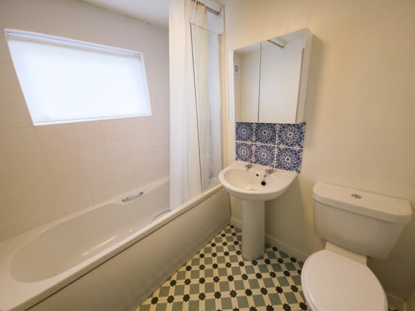 Family bathroom with bath and patterned floor tiles