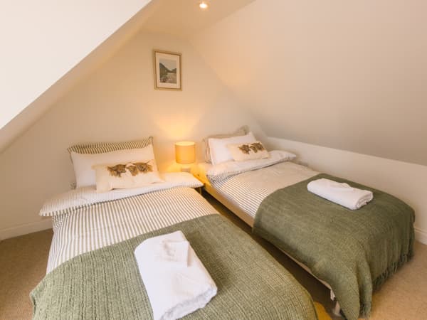 Twin beds under the attic ceiling